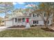 Charming two-story home with a red front door and meticulously maintained landscaping at 4307 Pope Rd, Durham, NC 27707