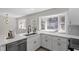 Charming kitchen with white cabinetry, stainless steel appliances, and natural light at 4307 Pope Rd, Durham, NC 27707