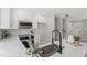 Bright kitchen featuring white cabinets, modern appliances, and a stylish black faucet at 4307 Pope Rd, Durham, NC 27707