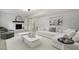 Bright living room with fireplace, white sofa, neutral decor, and lots of natural light at 4307 Pope Rd, Durham, NC 27707