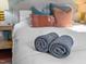 Comfortable bedroom setting with decorative pillows and rolled towels on the bed at 449 Parnell Dr, Raleigh, NC 27610