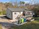Home featuring a rear deck and ample parking with landscaping at 449 Parnell Dr, Raleigh, NC 27610
