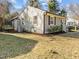 White brick home with tidy garden beds and mature landscaping surrounding property at 449 Parnell Dr, Raleigh, NC 27610