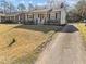 Charming single-story home with gray siding, a red front door, and a well-manicured lawn at 449 Parnell Dr, Raleigh, NC 27610