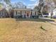 Charming gray home features a manicured front yard and a welcoming red front door at 449 Parnell Dr, Raleigh, NC 27610