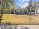 Inviting single-story house with gray siding, black shutters, and a red front door at 449 Parnell Dr, Raleigh, NC 27610