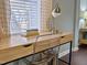 Bright home office features a modern desk, clear chair, and a large window for natural light at 449 Parnell Dr, Raleigh, NC 27610
