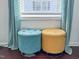 Sitting area showcasing two round, tufted ottomans in front of a window with sheer curtains at 449 Parnell Dr, Raleigh, NC 27610