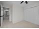 Neutral bedroom with carpeted floors, closet and view into hall at 4929 Liverpool Ln, Raleigh, NC 27604