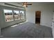 A bright bedroom boasts plush carpeting, a ceiling fan, and lots of natural light at 526 Billingshurst Way # 211, Knightdale, NC 27545