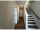 Bright hallway featuring hardwood floors and a staircase with a light wood railing at 526 Billingshurst Way # 211, Knightdale, NC 27545