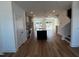 Open-concept living room and kitchen with hardwood floors and stainless steel appliances at 526 Billingshurst Way # 211, Knightdale, NC 27545