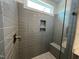 Close-up view of a tiled shower with a built-in bench and niche at 526 Billingshurst Way # 211, Knightdale, NC 27545