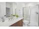 Bathroom features a single vanity with a quartz countertop and walk-in shower with glass door at 526 Billingshurst Way, Knightdale, NC 27545