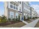 Modern townhome exteriors featuring stone accents and neat landscaping along the sidewalk at 526 Billingshurst Way, Knightdale, NC 27545