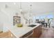 Modern kitchen island with quartz countertops, stainless steel appliances, and open dining area at 526 Billingshurst Way, Knightdale, NC 27545