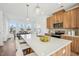 Bright kitchen with wooden cabinetry, quartz countertops, and pendant lighting over the island at 526 Billingshurst Way, Knightdale, NC 27545