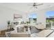 Bright living room features modern decor, lots of natural light, and access to outdoor balcony at 526 Billingshurst Way, Knightdale, NC 27545