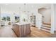 Open-concept space with staircase, kitchen island, and a cozy living area with plenty of natural light at 526 Billingshurst Way, Knightdale, NC 27545
