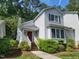Inviting home exterior with a red door, surrounded by lush landscaping and trees at 595 Weathersfield # A, Pittsboro, NC 27312