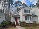 Inviting home exterior with a red door and lush trees in a desirable neighborhood at 595 Weathersfield # A, Pittsboro, NC 27312