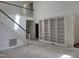 Spacious foyer showcasing staircase and custom built-in bookshelves at 595 Weathersfield # A, Pittsboro, NC 27312
