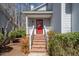 Inviting front entrance featuring a bright red door, brick steps, and white railings at 595 Weathersfield # A, Pittsboro, NC 27312