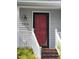 Inviting home entrance featuring a vibrant red door and white railings and steps at 595 Weathersfield # A, Pittsboro, NC 27312