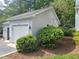 Exterior view of the garage with a lawn and surrounding landscaping at 595 Weathersfield # A, Pittsboro, NC 27312