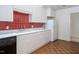 Bright kitchen with white cabinets, red tile backsplash, and stainless steel appliances at 595 Weathersfield # A, Pittsboro, NC 27312