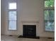 Bright living room featuring a fireplace and natural light from large windows at 595 Weathersfield # A, Pittsboro, NC 27312