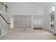 Bright living room with carpet, a staircase, and a built-in bookcase at 595 Weathersfield # A, Pittsboro, NC 27312
