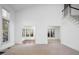 Spacious living room with carpet, natural light, and seamless flow to sunroom at 595 Weathersfield # A, Pittsboro, NC 27312