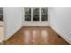 Bright room with hardwood floors and a large window with neighborhood view at 595 Weathersfield # A, Pittsboro, NC 27312