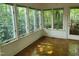 Bright sunroom with hardwood floors, scenic backyard views, and direct outdoor access at 595 Weathersfield # A, Pittsboro, NC 27312