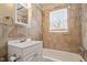 Bathroom featuring tile surround, vanity, and natural light at 617 Bernice St, Durham, NC 27703