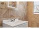 Bathroom featuring earth tone tile work, a medicine cabinet, and a showerhead at 617 Bernice St, Durham, NC 27703