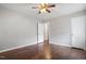A basic bedroom showcases a ceiling fan, hardwood floors, and a window at 617 Bernice St, Durham, NC 27703