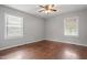 Bedroom with hardwood floors, two windows, and neutral paint at 617 Bernice St, Durham, NC 27703
