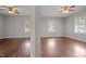 Two bedrooms with hardwood flooring and a ceiling fan feature separate windows at 617 Bernice St, Durham, NC 27703