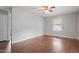 A simple bedroom features hardwood floors, a ceiling fan, and a window at 617 Bernice St, Durham, NC 27703