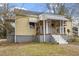 Charming home with covered front porch, brick foundation, and awnings at 617 Bernice St, Durham, NC 27703