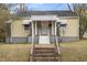 Charming single Gathering home featuring a quaint covered porch, white columns, and brick steps leading to the front entrance at 617 Bernice St, Durham, NC 27703