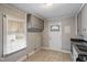 An eat-in kitchen area with a window, tile flooring, and a side door entrance at 617 Bernice St, Durham, NC 27703