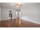 The living room features hardwood flooring, a ceiling fan, and views into the kitchen area at 617 Bernice St, Durham, NC 27703