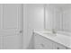 Well-lit bathroom featuring a vanity with white countertops, neutral floors, and white walls at 625 Spellbrook Rd, Zebulon, NC 27597