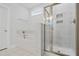 Bright bathroom featuring a shower and tub with stylish marble accents and neutral tile floors at 625 Spellbrook Rd, Zebulon, NC 27597