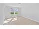 Well-lit bedroom with neutral carpet and a large window offering backyard views at 625 Spellbrook Rd, Zebulon, NC 27597