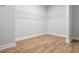 Spacious walk-in closet with hardwood floor and built in wire shelving, great for organization at 625 Spellbrook Rd, Zebulon, NC 27597