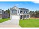 Beautiful two-story home with a well-manicured lawn and attached two-car garage at 625 Spellbrook Rd, Zebulon, NC 27597